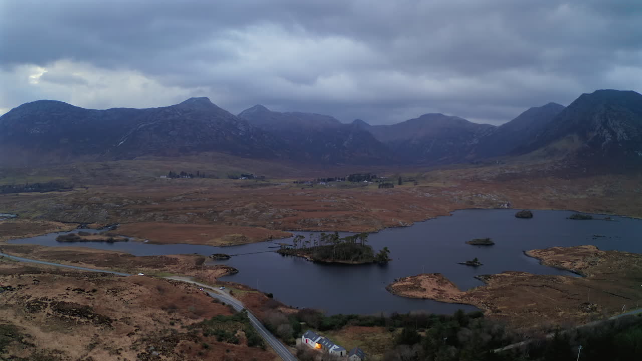 Establishing aerial shot of Connemara’s dramatic twilight scene with Twelve Bens and Derryclare Lough