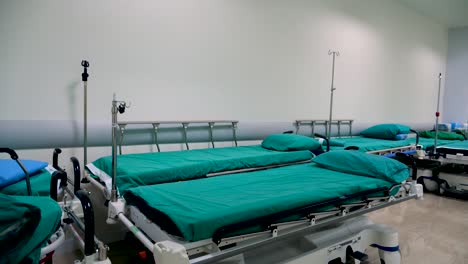 Multiple-Stretcher-Cover-By-Green-Cloth-Stand-By-In-Hospital