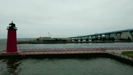 Aerial-drone-footage-reveal-from-lighthouse-on-the-waterfront-to-the-Hoan-Bridge-in-downtown-Milwaukee-on-gloomy-day