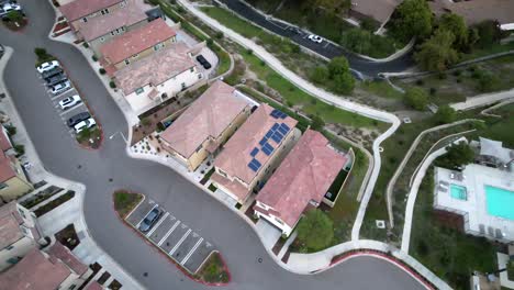 Valencia-residential-district-roof-solar-panels-reflecting-in-sunlight-aerial-descending-view-fly-over