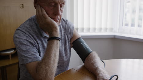 senior man checking blood pressure