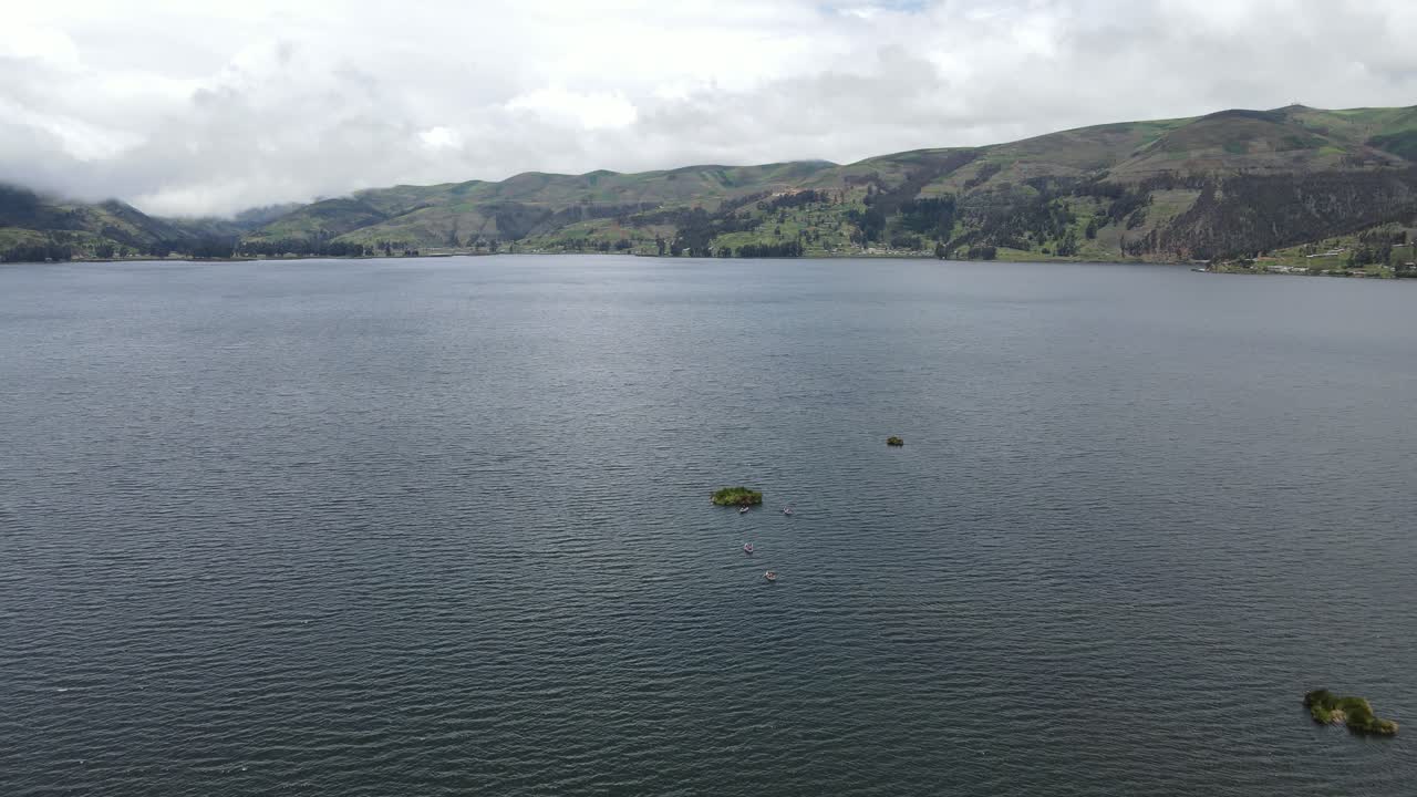Serene drone footage showing people rowing a small boat on a tranquil lake, capturing the beauty of outdoor adventure and stillness