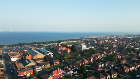 Skegness,-Lincolnshire,-comes-to-life-in-this-aerial-footage,-featuring-its-picturesque-coastline,-vibrant-town,-iconic-pier,-and-the-enchantment-of-a-summer-evening