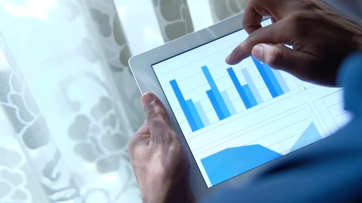 Business Person Analyzing Data on Tablet