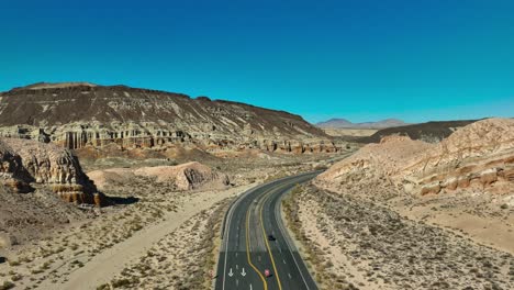 a view from over california highway 58 as in passes through a canyon between sandstone cliffs on a clear day in the mojave desert