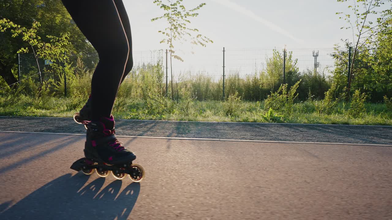 Woman Rollerblading in a City Park at Sunrise