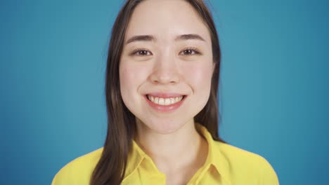 Smiling-fun-and-happy-Asian-young-woman-looking-at-camera.