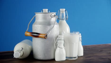 milk in bottles, glass and cans on the table slowly rotates.