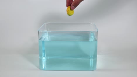 dropping a ball into a container of liquid