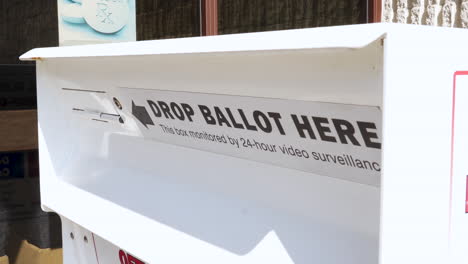 drop ballot here sign and slot with arrow for mail-in election voting box