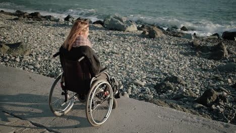 disabled woman on wheelchair at the beach