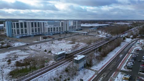 train traveling through a snowy cityscape in segefeld falkensee. fantastic aerial view flight drone top down above view
