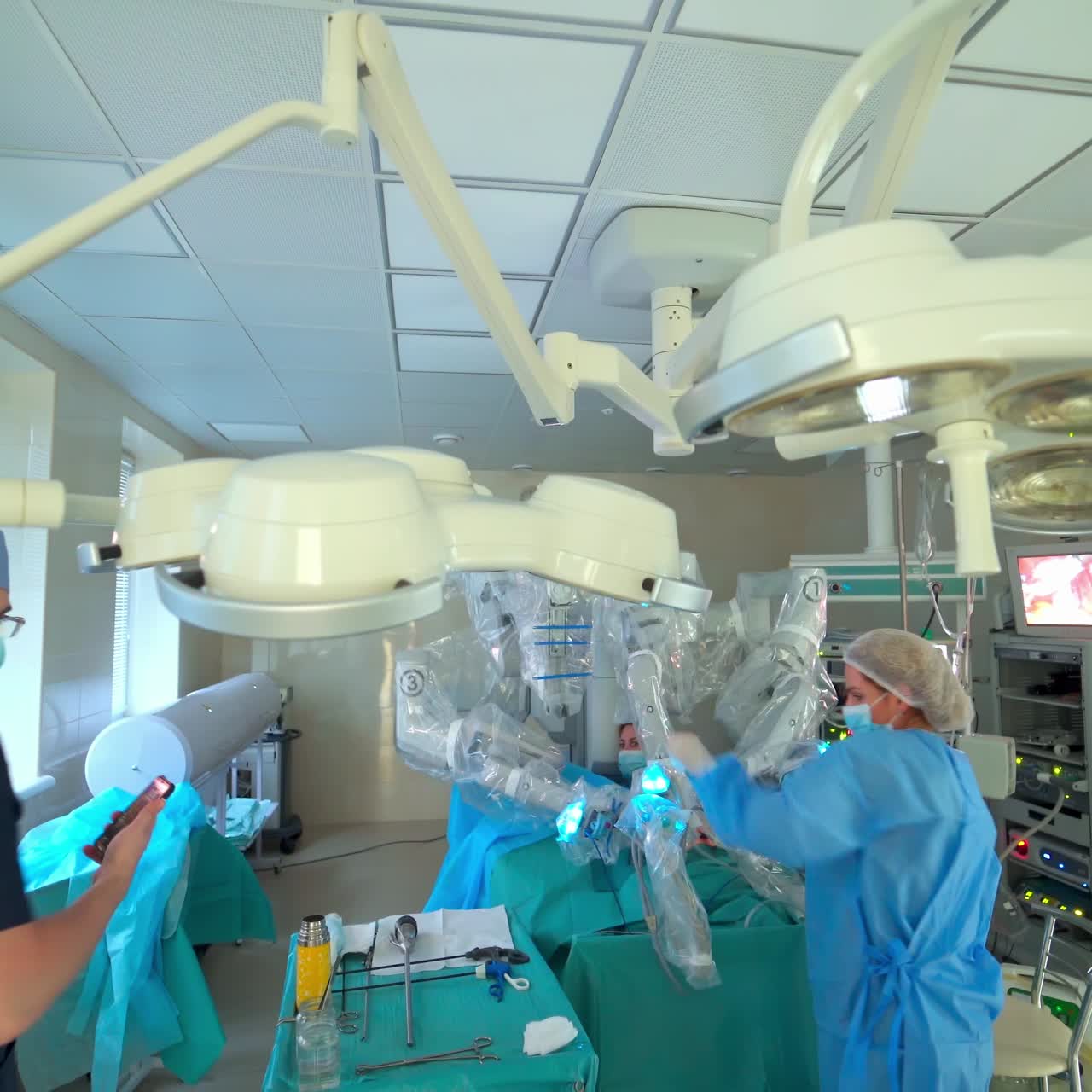 Minimal invasive surgery with medical robot. Group of surgeons operation in hospital room with surgery equipment