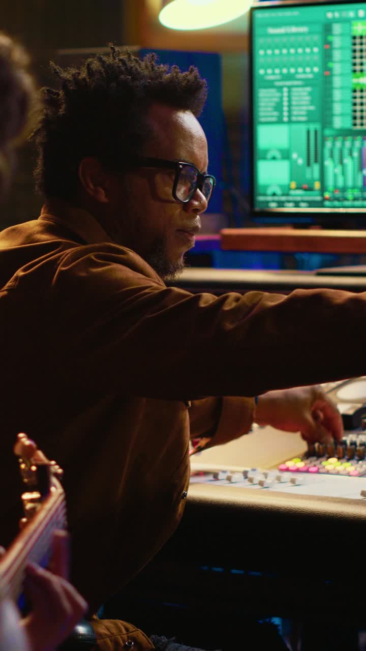 Audio Engineer Working on Sound Mixing Console in Recording Studio