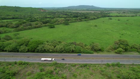 aerial: flying along the famous panamerican highway surrounded by lush greenery.