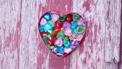 heart-shaped box filled with colorful candies