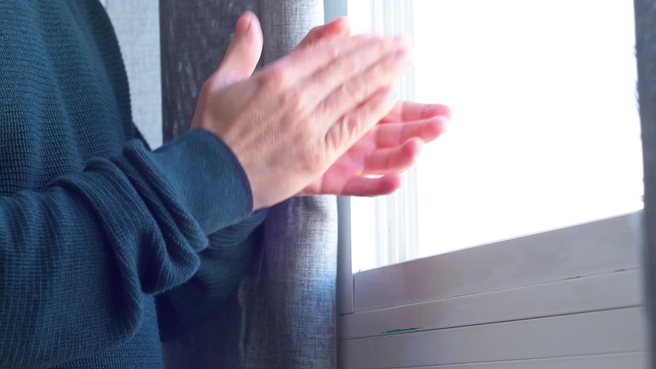 창문 앞에서 손뼉을 치는 모습