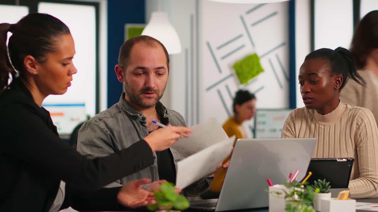 Authentic diverse group of enthusiastic business people using laptop computer