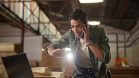 man talking on phone in warehouse