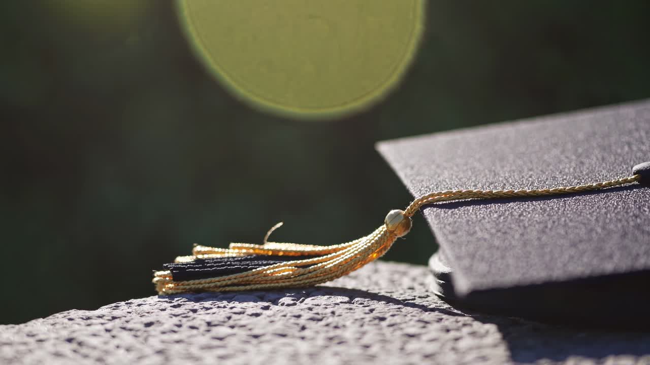 Close-up of a graduation cap with tassel, captured at a low angle