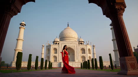 woman in red sari posing in front of the taj mahal