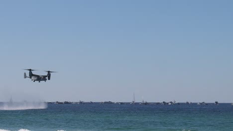 drone flies over sea, creating water spray