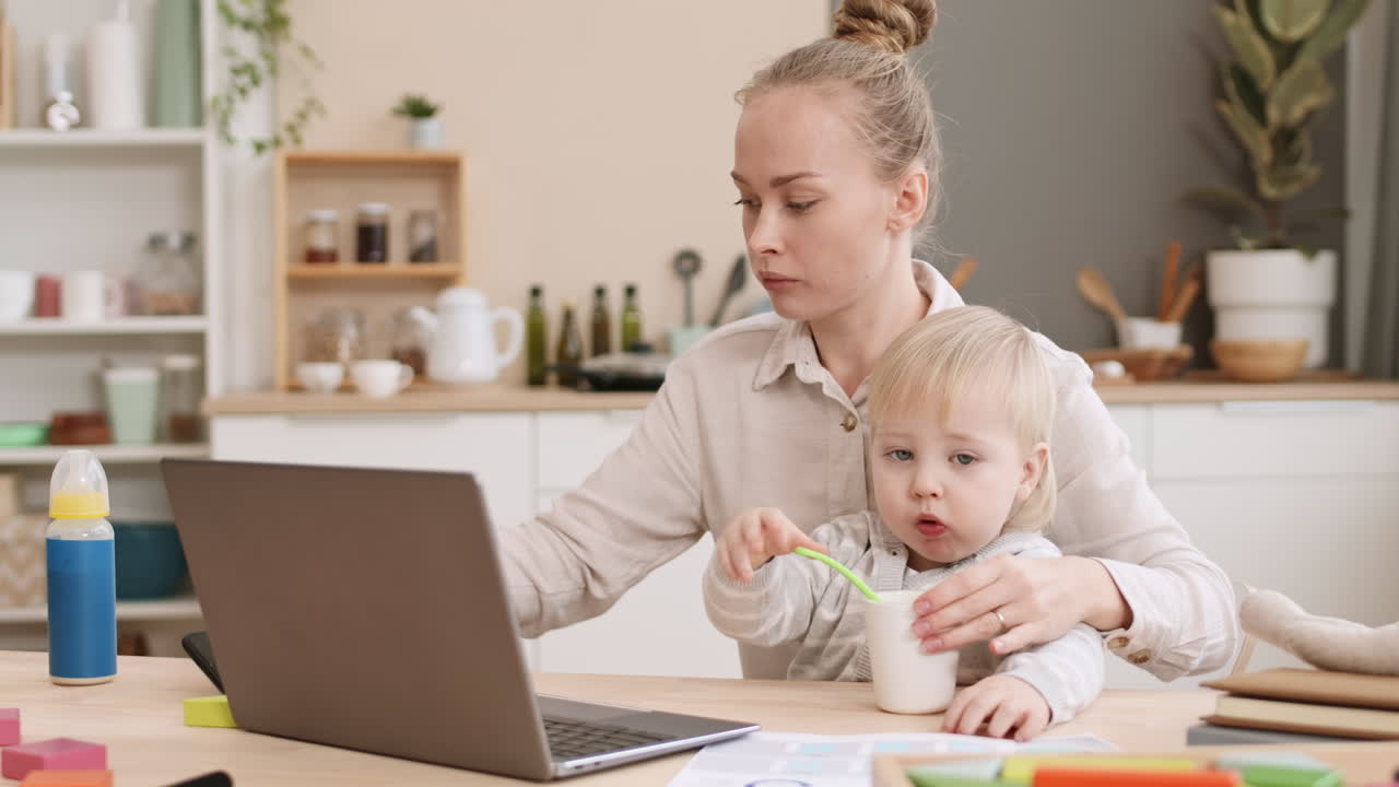 Working Mom Feeding Toddler at Home