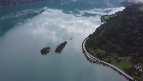 Two-little-islands-in-the-fjord-water-in-Norway-by-Drone