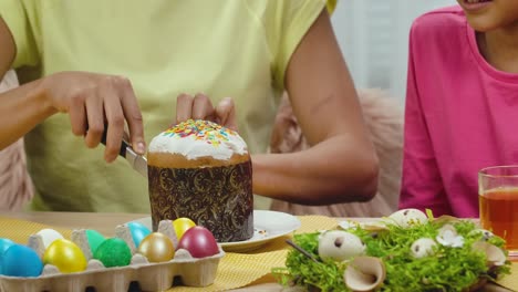 Family Celebrating Easter with Cake and Eggs