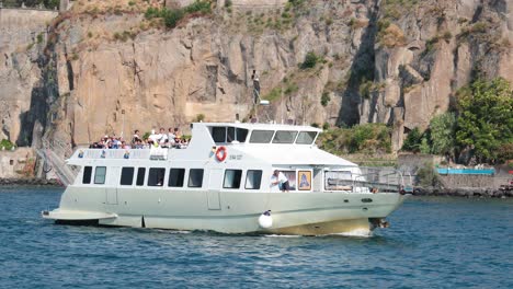 passenger ship cruising near rocky sorrento coastline