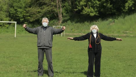 active senior old couple. man and woman do stretching physical exercises