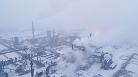 steam rises from industrial complex on zug island during heavy snowfall in detroit