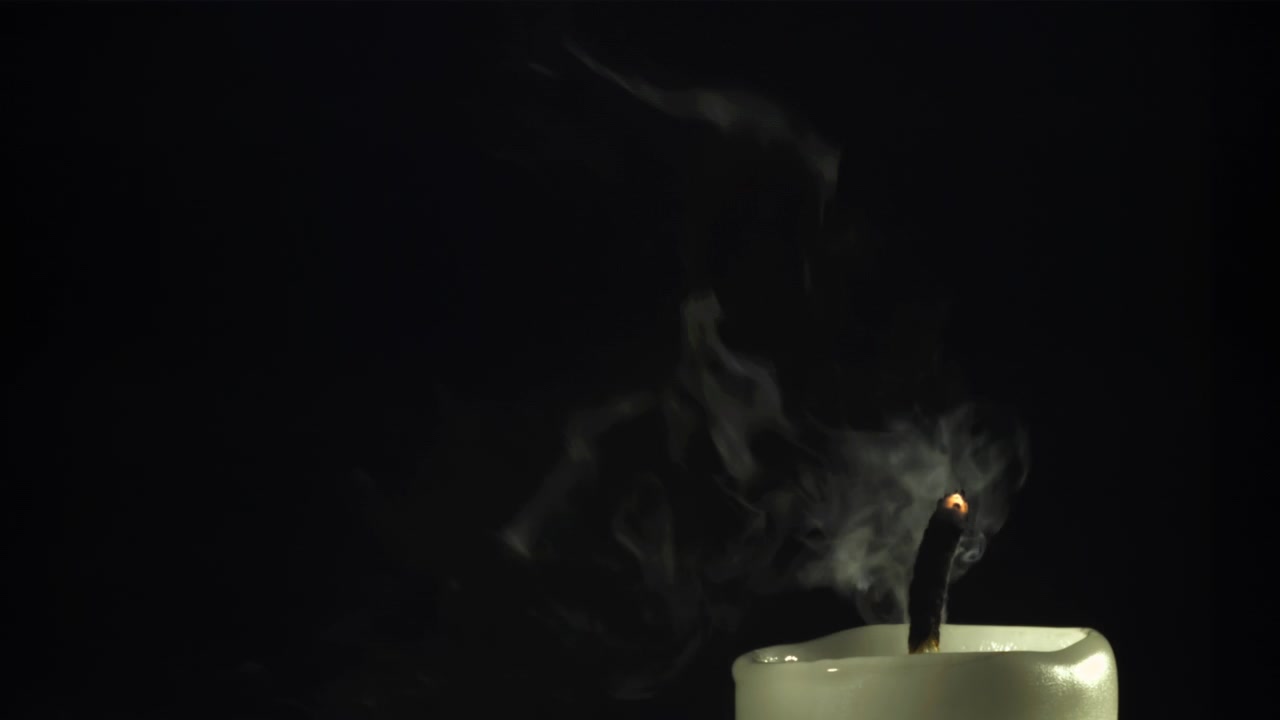 Close-up of a Candle Flame Being Extinguished with Smoke