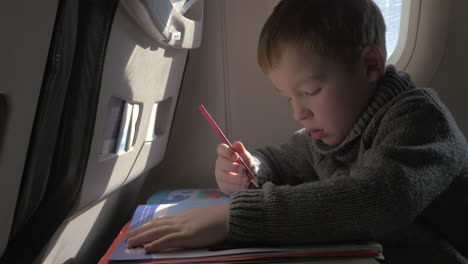 Close-up-view-of-small-boy-learning-to-writing-with-pencil