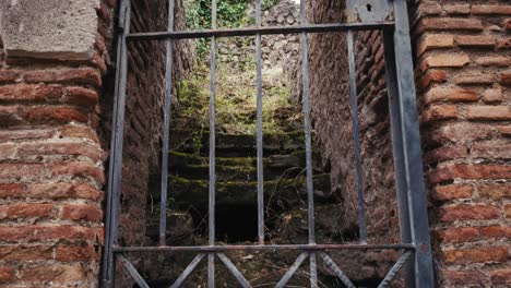 view of iron gate to ancient stairs, pompeii, italy