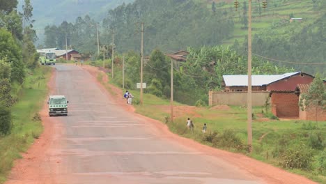 a minibus travels down a rural road in rwanda