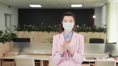 Young-girl-in-the-office-sprays-antiseptic-on-his-hands-and-washes-thoroughly