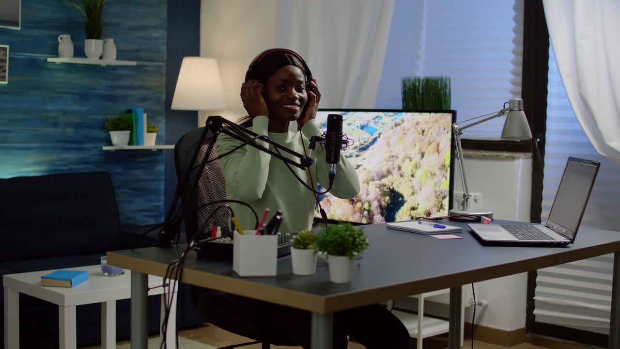African blogger influencer putting on headset and smiling