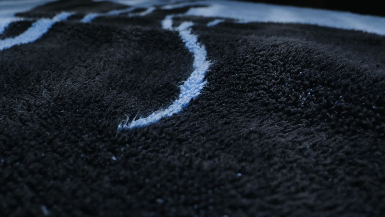 Close-up of a dark blue and black fleece blanket or towel