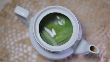 The-Man-Puts-Two-Tea-Leaves-Into-A-Teapot-And-Fills-With-Boiling-Water-1