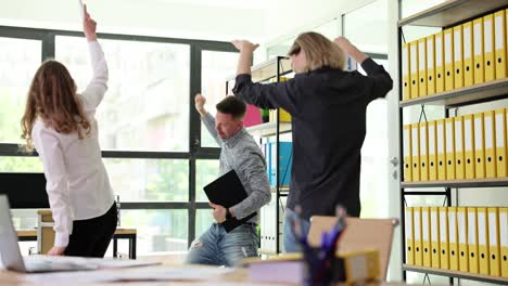 excited office workers celebrating success