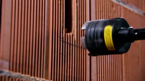 drilling a hole in a brick wall