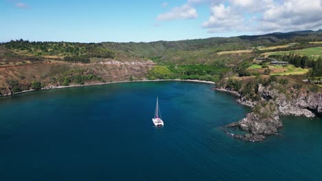 aerial view of a sailboat in a serene tropical bay