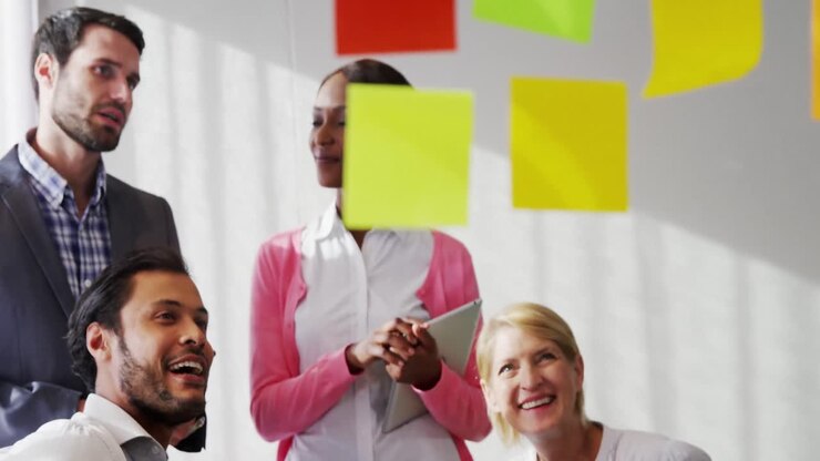 Businesspeople interacting over sticky notes