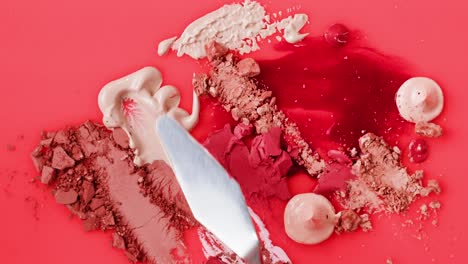 makeup swatches and tools on a pink palette