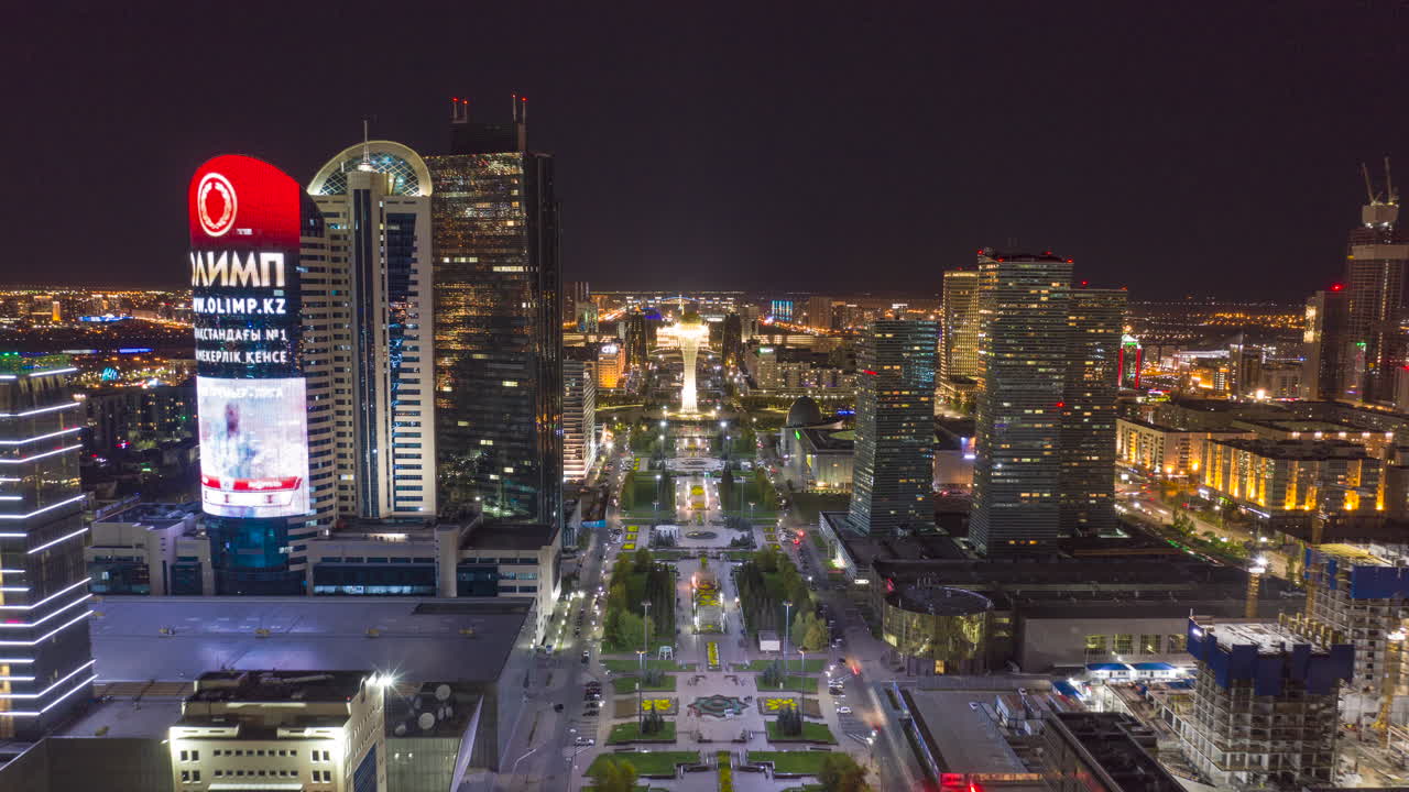An aerial view hyperlapse over Nurzohl Boulevard, Nur Sultan, Kazakhstan. At Night revealing the entertainment centre.