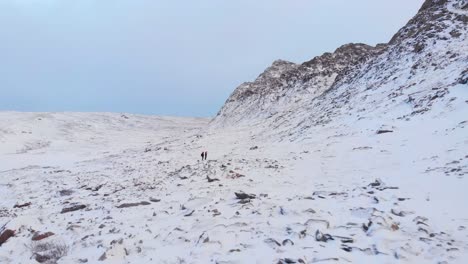 excursionistas aventureros perdidos en el vasto paisaje blanco helado y las montañas rocosas en laponia, suecia - tiro aéreo sobrevolado