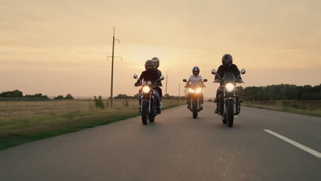 bikers ride in a row on the highway