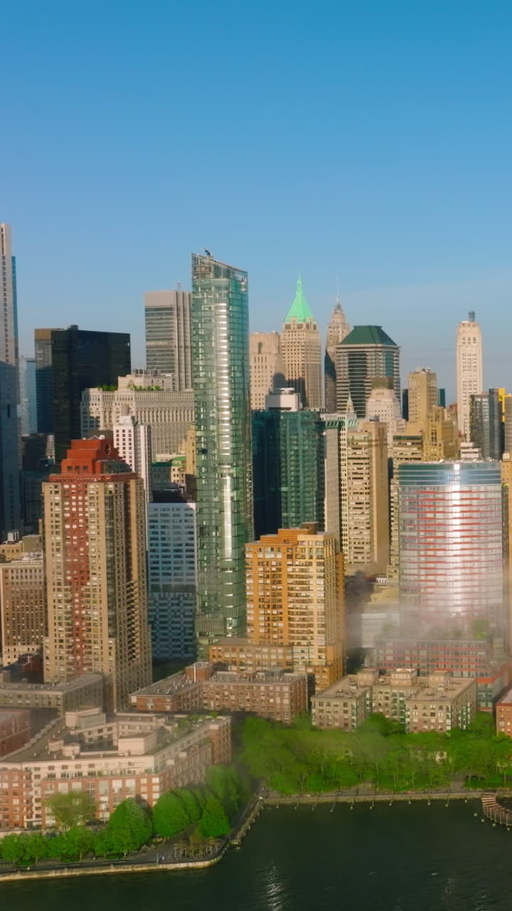 Manhattan island beautiful architecture. Fog coming to the city from blue waters of the river. Aerial perspective. Vertical video