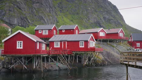 tilt down reveal footage of the red rorbu houses in the beautiful fisher village of å in the lofoten islands, norway